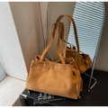 Detail view of suede tote bag featuring drawstring closure and metal ring eyelets - Brown