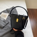 Classic black leather bucket bag with gold hardware and adjustable crossbody strap - Black