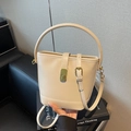 Elegant cream white bucket bag with golden hardware and adjustable crossbody strap - Off-white