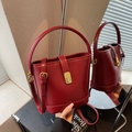 Fashionable dark red bucket bag with gold hardware and mirror reflection detail - Burgundy