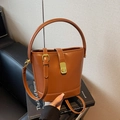 Chic brown bucket bag in smooth PU leather with golden buckle and adjustable strap - Brown