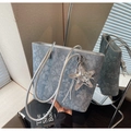 Close-up of blue-grey printed tote bag with silver star charm and floral pattern - With Charm / Light Blue