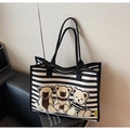 Close-up of striped canvas tote bag featuring three flocked teddy bear patches and black handles - Black