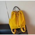 Detail of bright yellow nylon drawstring backpack with black woven handle on textured background - Yellow