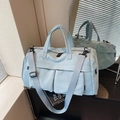 Light blue waterproof travel bag with double handles and adjustable padded shoulder strap - Blue