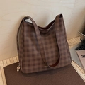 Brown checkerboard pattern hobo bag made of synthetic leather on a display stand - Brown