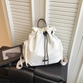 Chic beige canvas drawstring bucket backpack with dark brown leather handles and side pockets - White