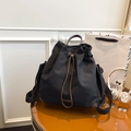 Black canvas drawstring bucket backpack with dark brown leather trim and handles - Black
