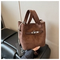 Detailed side view of a brown suede bucket bag with metal buckle and drawstring texture - Brown
