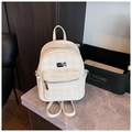 Detail of a cream checkered backpack featuring a zip pocket and metal logo plate - Off White