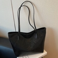 Classic large black oil-wax tote bag with thin straps and metallic logo detail - Black
