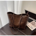 Retro dark brown large tote bag with textured faux leather finish on leather bench - Brown