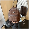 Detail of a brown plaid mini backpack with silver metal zippers and front pocket - Brown