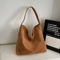 Chic brown suede tote bag featuring a spacious hobo design and a wide shoulder strap - Brown