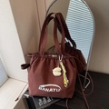 Dark brown nylon drawstring tote bag with BANATU logo and cute plush charm accessory - Coffee with Pendant