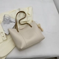 Cream tote bag with dark brown handles and a cute plush bunny charm for daily commute - Off White
