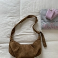 Detail of brown suede hobo bag featuring wide strap with knot detail and large capacity - Brown