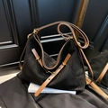 Hobo style shoulder bag in black matte suede with brown leather straps and metal buckle - Black