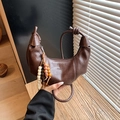 Brown matte leather dumpling bag with knotted strap and wooden bead charm accessory - Brown