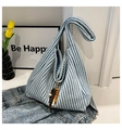 Detail of blue and white striped knitted tote bag with wooden bead fringe tassel - With Charm / Blue