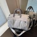 Beige gym travel bag with large capacity, featuring quilted texture and shoulder strap - Gray