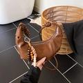 Dark brown leather dumpling bag with knotted handle and decorative beaded charm - Brown