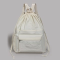 Detailed front view of off-white drawstring nylon backpack with zipper pockets - White