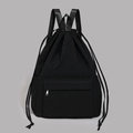 Detail of waterproof black drawstring backpack featuring a silver metal zipper front pocket - Black
