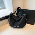 Black nylon crescent crossbody bag with bow strap detail and white MUCAIXI branding - Black