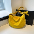 Bright yellow dumpling crossbody bag with large bow shoulder strap and brand lettering - Yellow