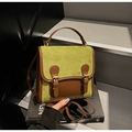 Detail of vintage patchwork backpack in green suede and brown leather on steps - Green