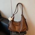 Retro dark brown leather hobo bag with plush bear charm and tassel detail on book - Caramel color