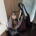 Dark brown matte leather tote bag with plush bear charm and adjustable shoulder strap - Brown