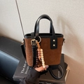 Brown faux suede bucket bag with star embossing and wooden bead charm detail - With Charm / Black and Brown