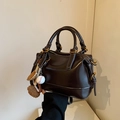 Deep brown glossy faux leather handbag with baseball charm and contrast stitching detail - With Charm / Black