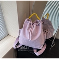 Light purple drawstring canvas backpack with bright yellow woven handle and side pockets - Purple