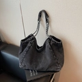 Vintage dark washed denim tote bag with silver chain strap on leather sofa backdrop - Black