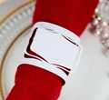 Gros plan d'un rond de serviette ajouré blanc sur une serviette rouge texturée - Blanc