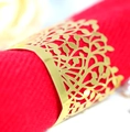 Golden hollow leaf napkin ring with metal plating on a red fabric napkin for table decor - Reflective Gold