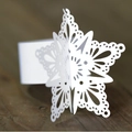 White laser-cut snowflake napkin ring with intricate lace detail on rustic wood background - 50 Pieces / White