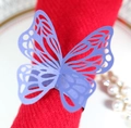 Elegant laser-cut light blue butterfly napkin ring with a pearl finish on red fabric - Sapphire Blue