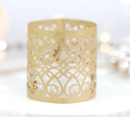 Macro view of gold laser-cut paper tea light wrap with elegant scroll patterns - Kraft Paper Color