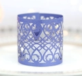 Macro view of purple laser-cut paper decorative wrap with intricate floral patterns - Sapphire Blue