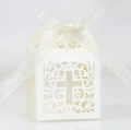 Detail of white laser-cut wedding favor box featuring an elegant hollow cross design - Ivory