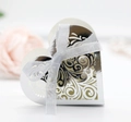 Detail of silver heart-shaped hollow gift box with reflective finish and white ribbon bow - Reflective Silver