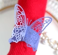 Detailed macro view of laser-cut purple butterfly napkin ring on a red napkin - Sapphire Blue