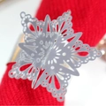 Polished silver metal snowflake napkin ring with hollow design on red napkin - Reflective Silver
