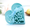 Macro shot of light blue heart-shaped laser-cut candy box with silk ribbon and LOVE text - Tiffany Blue