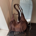 Deep brown suede hobo bag with long fringes and golden hardware on a leather strap - Brown