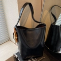 Minimalist black bucket shoulder bag with wooden bead tassel and long strap detail - With Charm / Black